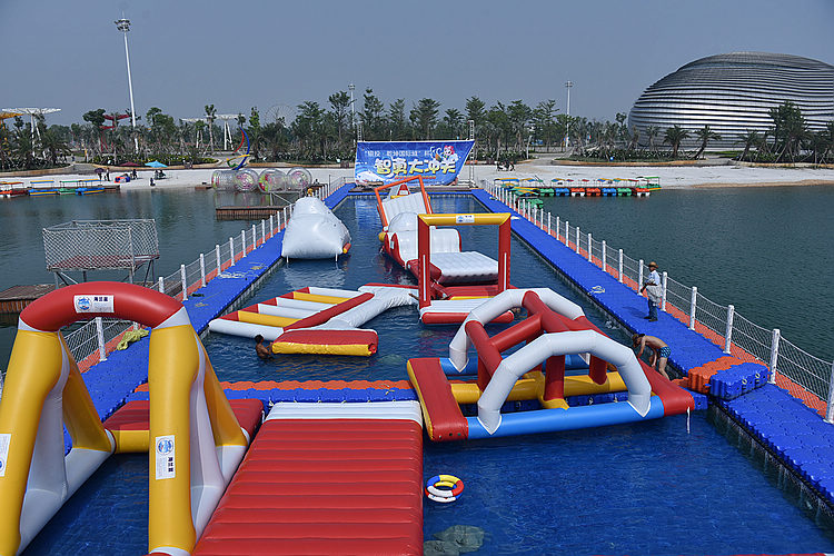 北海园博园的水上闯关项目"智勇大冲关"28日开放,有好多肌肉哥在水里